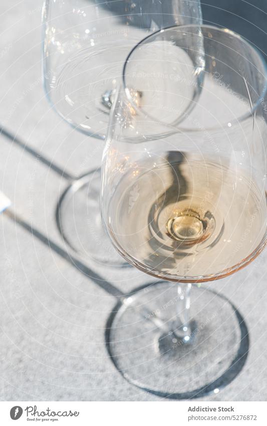 Gläser mit trockenem Weißwein Weinglas Alkohol alkoholisch Getränk übersichtlich kalt Beton Paar Kristalle tiefer Schatten trinken trocknen Glas Feinschmecker