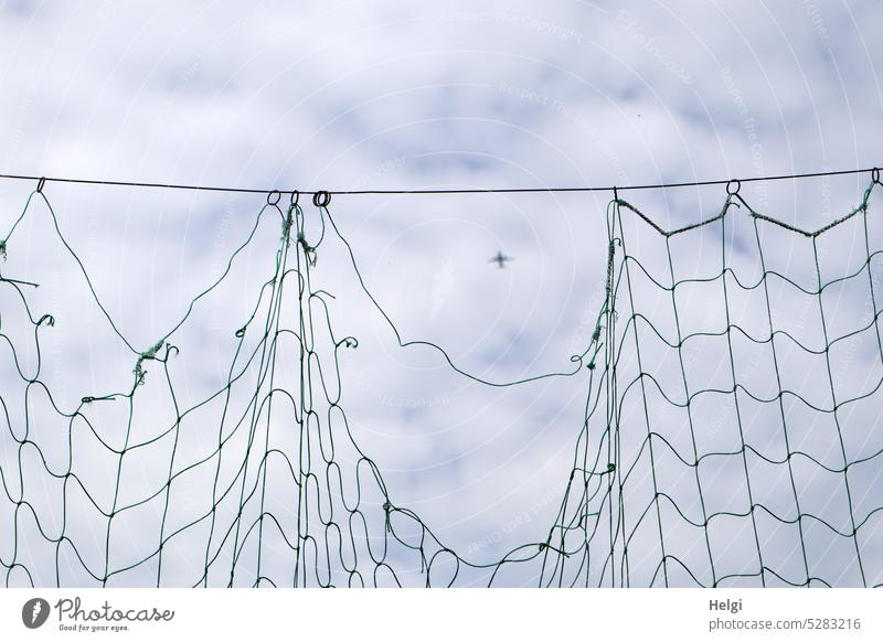 Mainfux-UT | Einflugschneise Netz Ballfangnetz Loch Flugzeug Himmel Wolken Flieger Entfernung kaputt Seil hängen Luftverkehr fliegen hoch oben blau grau weiß