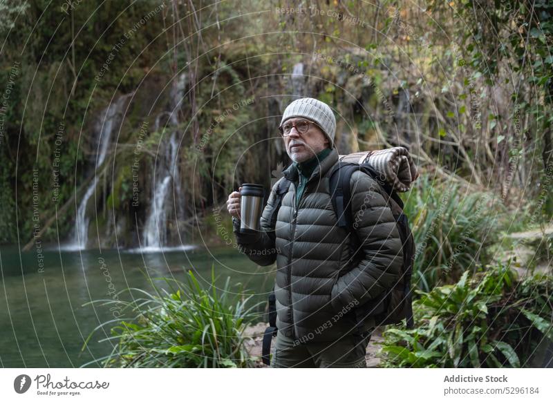 Nachdenklicher älterer Mann mit Thermoskanne und Rucksack Wald Ausflug Wanderer Reisender Natur genießen Berge u. Gebirge Seeufer Trekking männlich nachdenklich