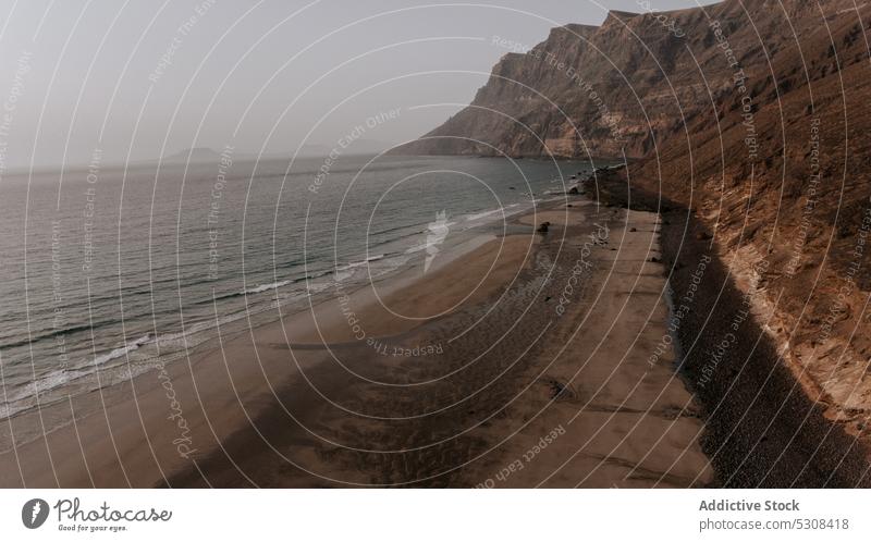 Sandstrand mit Felsformationen und Meer MEER Strand Sonnenuntergang Felsen winken felsig Landschaft Küste Natur Formation Meereslandschaft Ufer Spanien