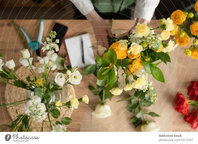 Frau arbeitet im Blumenladen Blumenhändler Blumenstrauß einrichten Werkstatt Floristik Arbeit Laden geblümt professionell Job Beruf Pflanze frisch Schürze