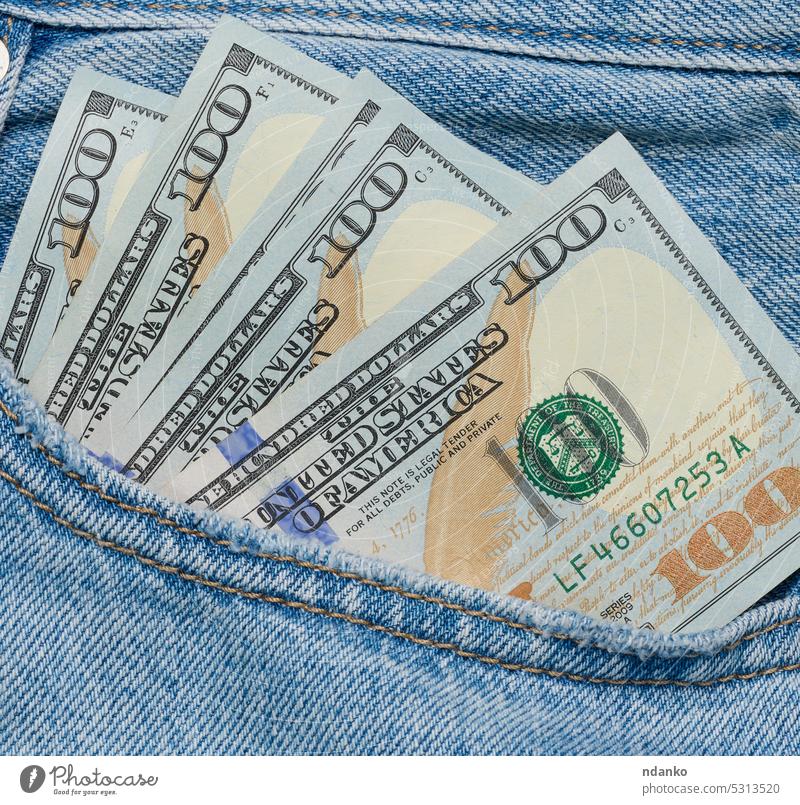 Amerikanische Papierdollarscheine ragen aus der Gesäßtasche einer Blue Jeans Rücken Banknote Rechnung blau Business Bargeld Nahaufnahme Währung Jeansstoff