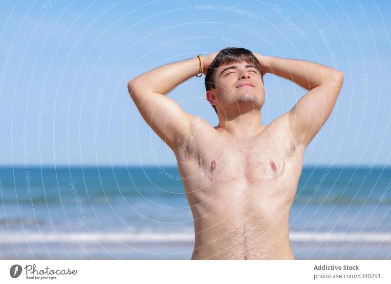 Schöner Schwuler ohne Hemd am Strand Mann Transgender schwul Sonnenbad Sand MEER oben ohne männlich lgbt lgbtq Homosexualität transsexuell androgyn queer