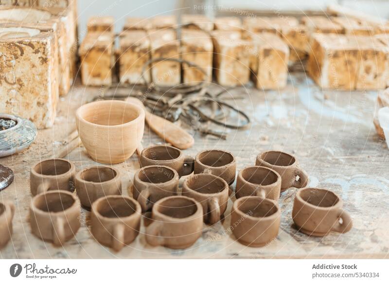 Unfertige Tonbecher auf Holztisch Vase Tasse Werkstatt handgefertigt unfertig kreativ Basteln professionell Töpferwaren Handwerk Tisch Keramik Sammlung Kunst