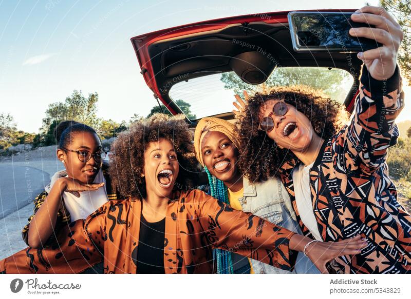 Glückliche schwarze Frauen nehmen Selfie in der Nähe von Auto Menschengruppe benutzend Smartphone Freund PKW heiter Straßenrand Sommer Afroamerikaner ethnisch