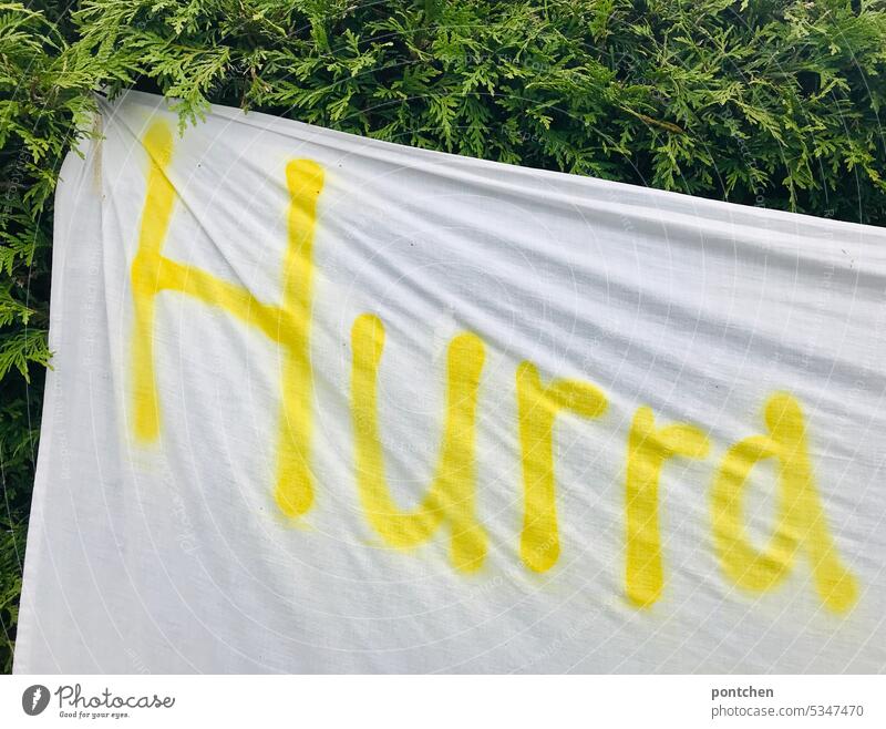 Hurra steht in gelb auf einem weißen Laken. hurra wort beschriftung laken ausdruck freude ausruf Schriftzeichen Buchstaben Schilder & Markierungen Typographie