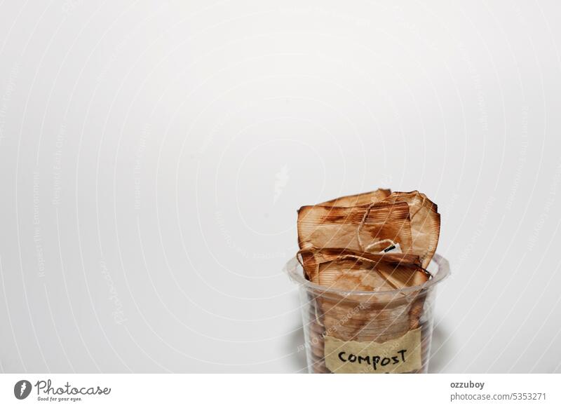 Trinkglas aus Plastik, gefüllt mit einem gebrauchten Teebeutel, auf dem mit Klebeband der Text "Kompost" steht Tasse Kunststoff satt Textfreiraum verwendet