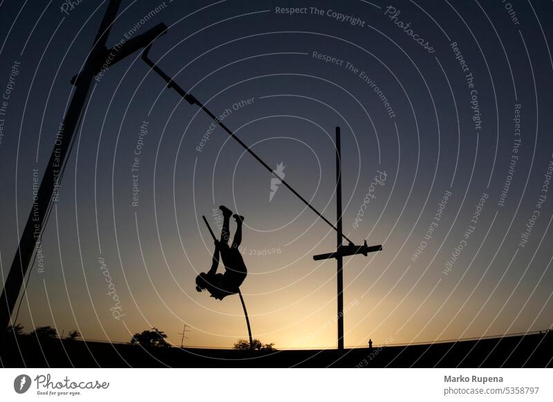 Stabhochsprung bei Sonnenuntergang durchführen erreichen Aktion aktiv Aktivitäten Athlet Leichtathletik Versuch Körper Herausforderung Meister Meisterschaft