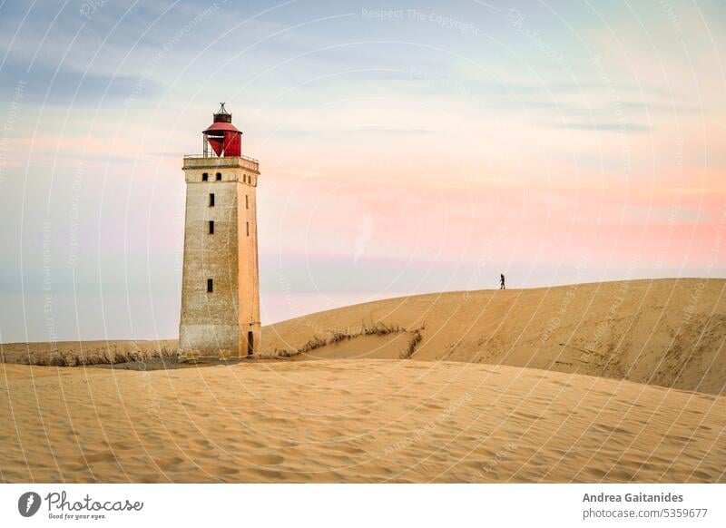 Die Silhouette eines Mannes auf dem Weg zum Leuchtturm Rubjerg Knude, morgens bei Sonnenaufgang, horizontal Düne sanddüne Sand Wanderdüne Rubjerg Knude