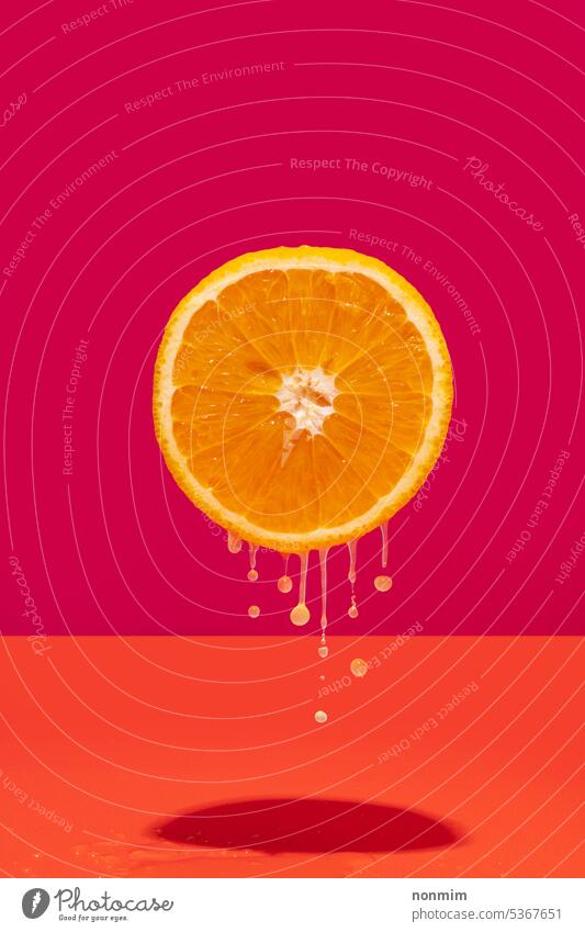 Konzeptuelle schwebende halbe Orange mit tropfendem Saft konzeptionell Hälfte orange pulsierend rosa fliegend Tropfen liquide süß Zucker Gesundheit Frucht