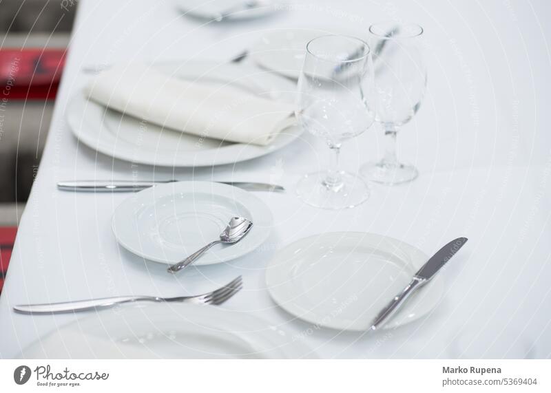 Weiße leere Teller und Gläser auf einem Tisch für eine Feier serviert Tischwäsche Gerichte Platten Restaurant Brille Geschirr weiß Sauberkeit Küchengeräte essen
