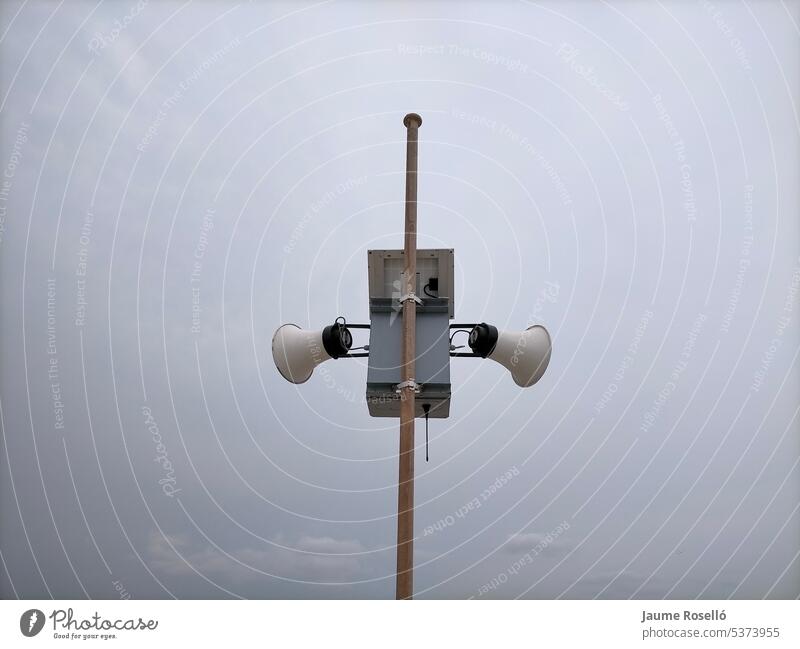 Zwei weiße Lautsprecher an einem Mast im Freien Inserat Audio Kommunizieren Kontrolle Stadtfest Information laut religiös Lautstärke Beförderung Stimme