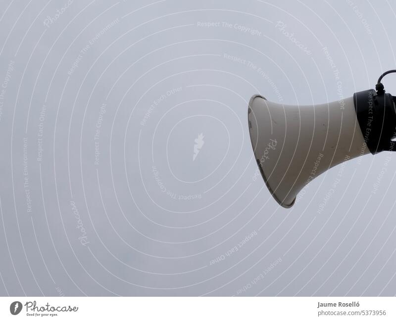 weißer farbiger Lautsprecher im Freien mit Himmel mit grauen Wolken auf einer Seite des Bildes mit Kopierraum. Inserat Audio Kommunizieren Kontrolle Stadtfest