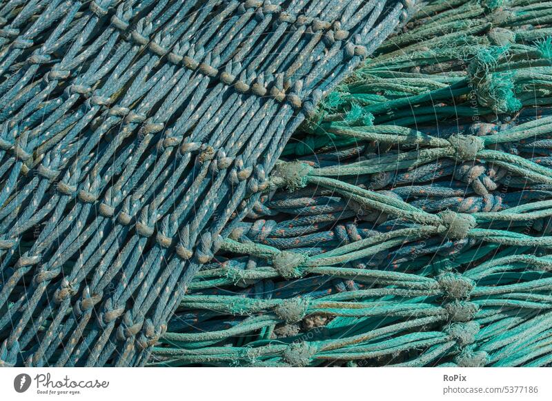 Gebrauchte Fischernetze auf einem Pier. Netz fishnet Fischerei Gewebe Gewerk Gewirr Seil Strick rope Maschen See Meer Hochsee Hochseefischer Gewerbe Jagd