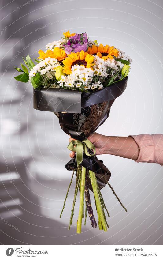 Crop-Frau mit Blumenstrauß Blumenhändler Geschenk präsentieren Haufen umhüllen aromatisch Flora Blütezeit Pflanze frisch geblümt Stil feiern Laden Floristik