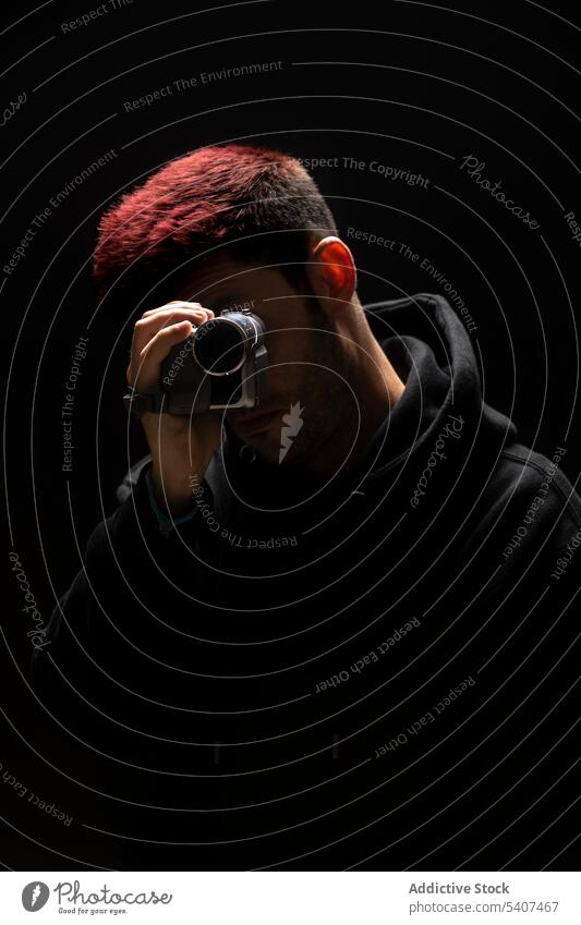 Anonymer junger Mann, der mit einer Videokamera fotografiert Fotokamera schießen Aufzeichnen benutzend digital Porträt Apparatur Stil modern Amateur Gerät vlog