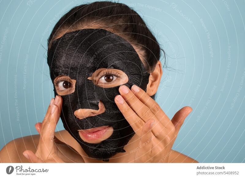 Frau mit Maske auf dem Gesicht im Studio Hautpflege Mundschutz Maske aus Bambuskohle Kosmetik Schönheitsprogramm bewerben Gesichtsbehandlung Porträt