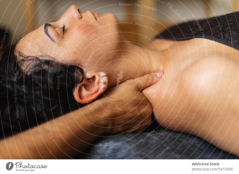 Crop Masseur Behandlung Frau Nackenmuskeln im Salon während des Tages Mann Massage Hals sich[Akk] entspannen Augen geschlossen Therapeut geduldig Finger kneten
