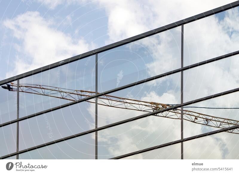 Kranausleger und Wolken spiegeln sich in einer Glasfassade Spiegelung Reflexion & Spiegelung Architektur Baustelle Blog Fassade Schönwetterwolken Dekowolken