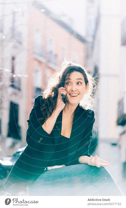 Junge Frau beim Spaziergang mit Smartphone Mobile Telefon Sitzen sprechend Mitteilung jung Person attraktiv brünett schön hübsch lange Haare lässig entspannt