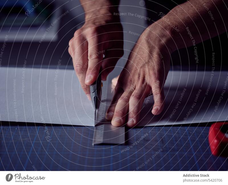 Arbeiter schneidet Blatt mit stationärem Messer auf der Oberfläche Kunstgewerbler Buchmacherei Page Schneiden Typographie Handwerk Bucheinband Arbeitsplatz