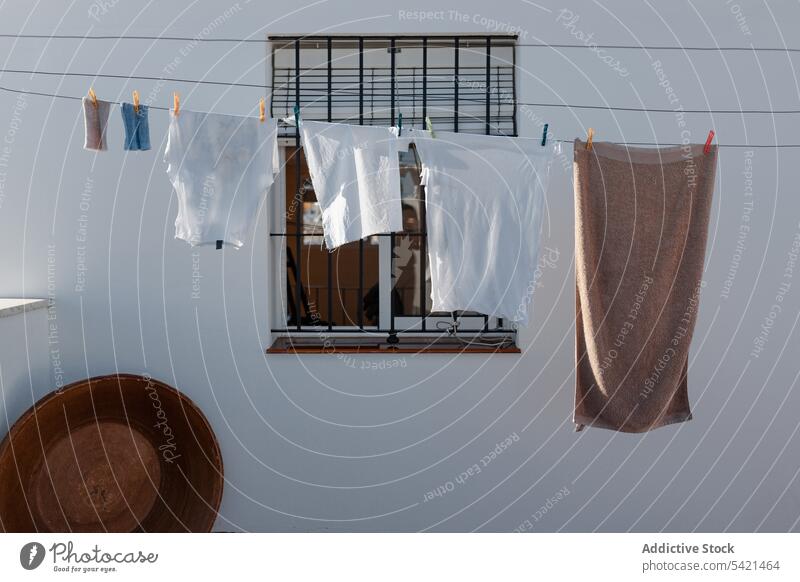 An einem Seil hängende Leinen im Hof Wäscherei Wäscheleine Land ländlich Waschen Stoff Haus Haushalt Hausarbeit Sauberkeit trocknen heimisch Fenster Arbeit