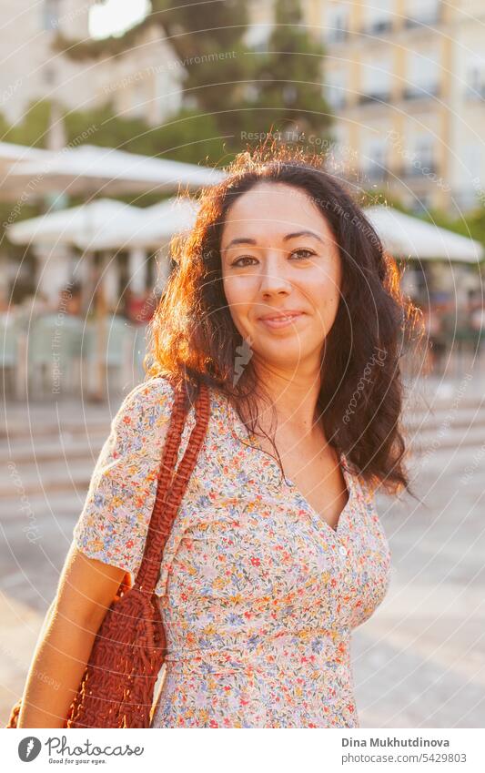 Schöne Touristin bei Sonnenuntergang in Valencia, Spanien. Brunette Frau Sommerkleid mit trendigen Häkeltasche zu Fuß die Straße. schön traumhaft Tourismus