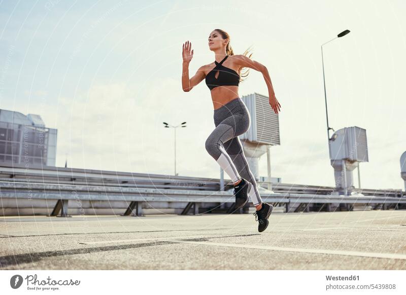 Junge Frau bei Laufübungen in der Stadt trainieren Joggen Jogging laufen rennen weiblich Frauen Fitness fit Gesundheit gesund Sport Erwachsener erwachsen Mensch