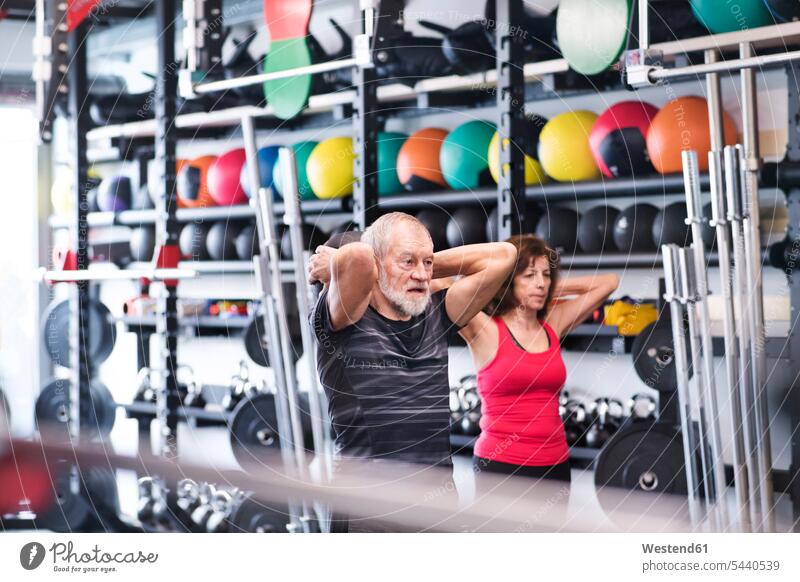Seniormandat und Frau im Fitnessstudio beim Training mit Medizinbällen trainieren Senioren alte ältere Fitnessclubs Fitnessstudios Turnhalle Erwachsene