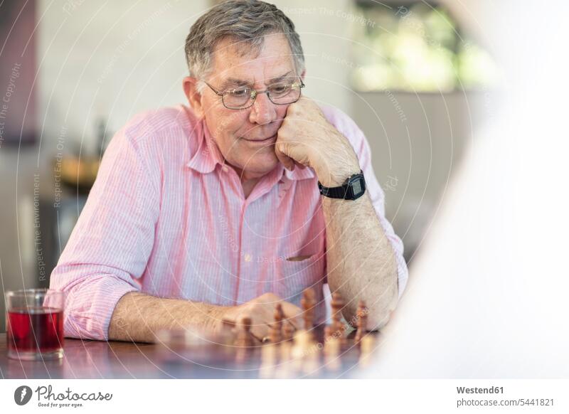 Älteres Ehepaar spielt zu Hause Schach spielen Paar Pärchen Paare Partnerschaft Zuhause daheim Senior ältere Männer älterer Mann Senioren Mensch Menschen Leute
