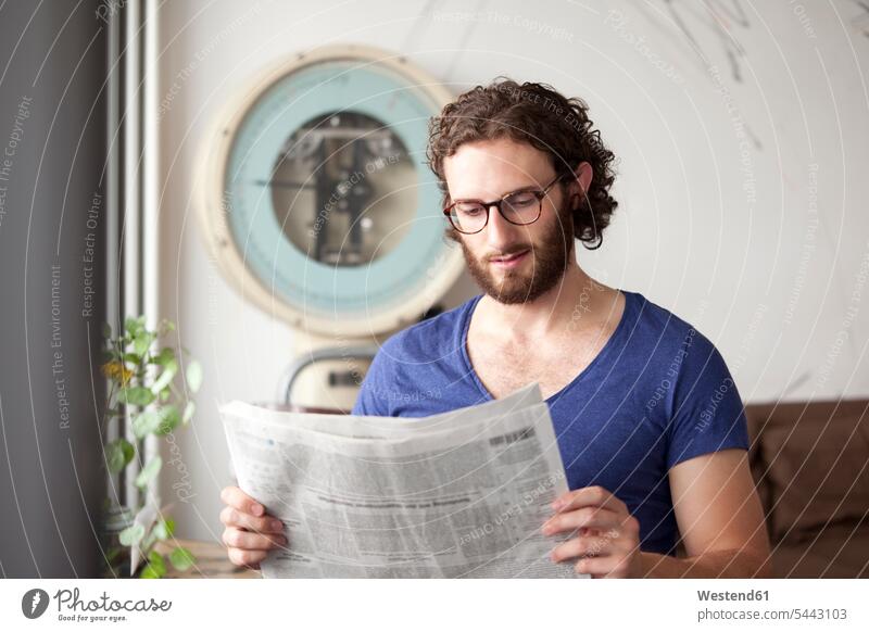 Porträt eines jungen Mannes, der in einem Café Zeitung liest Portrait Porträts Portraits Zeitungen Männer männlich Erwachsener erwachsen Mensch Menschen Leute