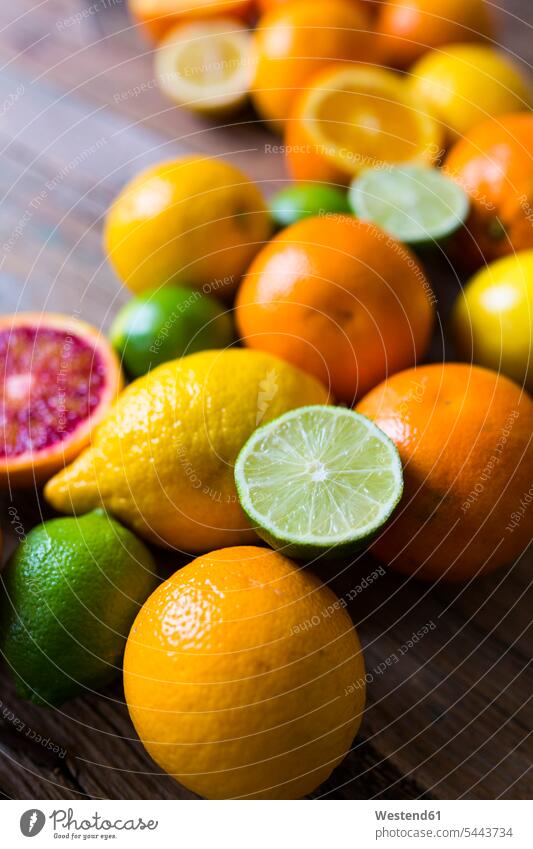 Geschnittene und ganze Limetten, Orangen und Zitronen auf Holz Food and Drink Lebensmittel Essen und Trinken Nahrungsmittel Limonen Limonelle Limonellen Fülle