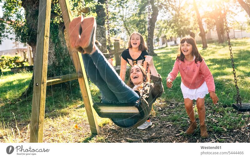 Drei glückliche Mädchen auf einem Spielplatz Glück glücklich sein glücklichsein Spielplätze Spielfeld Spielplaetze Schaukel Schaukeln Schwester Schwestern