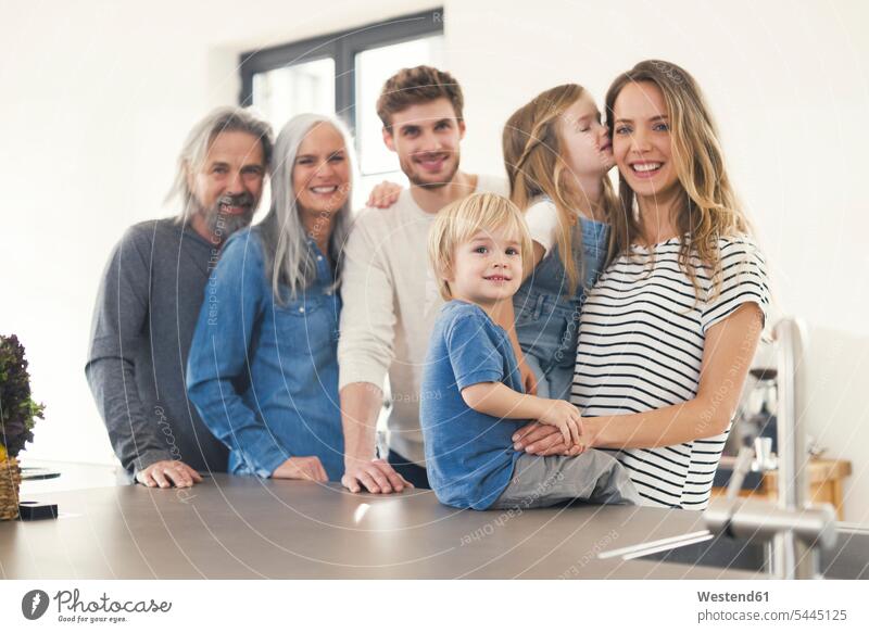 Glückliche Familie mit Großeltern und Kindern, die in der Küche stehen Familientreffen Küchen glücklich glücklich sein glücklichsein Gemeinsam Zusammen