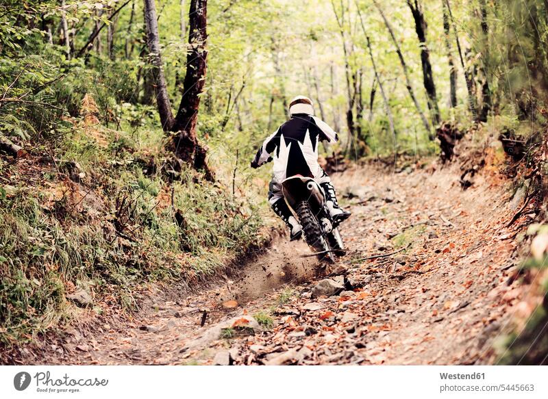 Italien, Motocross-Radrennen im toskanischen Wald Motocrossfahrer Motocross-Sportler Motocrosssportler junger Mann junge Männer Motorradhelm Motorradhelme