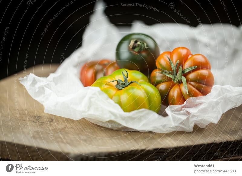 Verschiedene Ochsenherz-Tomaten auf Papier Niemand verschieden verschiedene Variation Abweichung Variationen Fokus Auf Den Vordergrund Fokus Auf Dem Vordergrund
