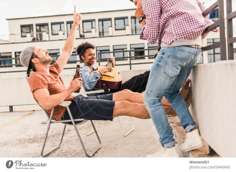 Drei Freunde feiern eine Party auf dem Dach Spaß Spass Späße spassig Spässe spaßig Parties Partys trinken Bier Dachterrasse Dachterrassen Gitarre Gitarren