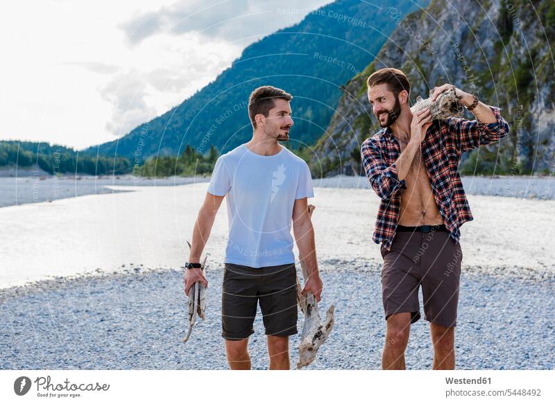 Deutschland, Bayern, zwei Freunde sammeln Brennholz in der Natur Feuerholz gesammelt Freundschaft Kameradschaft ansehen Trekking Trecking schauen sehend