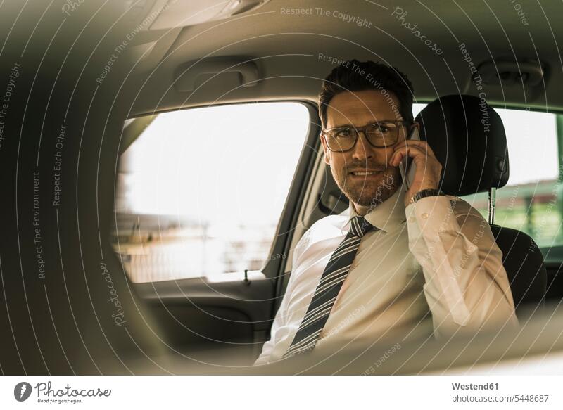 Erfolgreicher Geschäftsmann sitzt im Auto und telefoniert Erfolge erfolgreich Brille Brillen Hemd und Krawatte Beruf Berufstätigkeit Berufe Beschäftigung Jobs