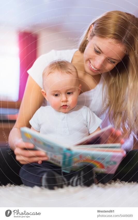 Mutter und kleiner Sohn schauen sich ein Bilderbuch an Söhne Mami Mutti Mütter Mama Baby Babies Babys Säuglinge Kind Kinder vorlesen Familie Familien Mensch