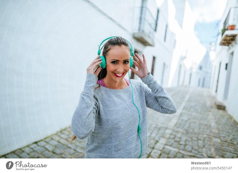 Junge Frau trägt Kopfhörer beim Training weiblich Frauen jung Musik hören Kopfhoerer Erwachsener erwachsen Mensch Menschen Leute People Personen 25-30 Jahre