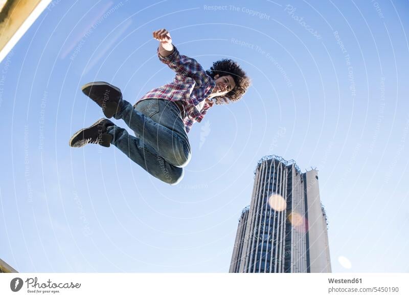 Junger Mann springt in die Luft springen hüpfen Luftsprung Luftsprünge einen Luftsprung machen Luftspruenge Männer männlich Sprung Spruenge Sprünge Erwachsener