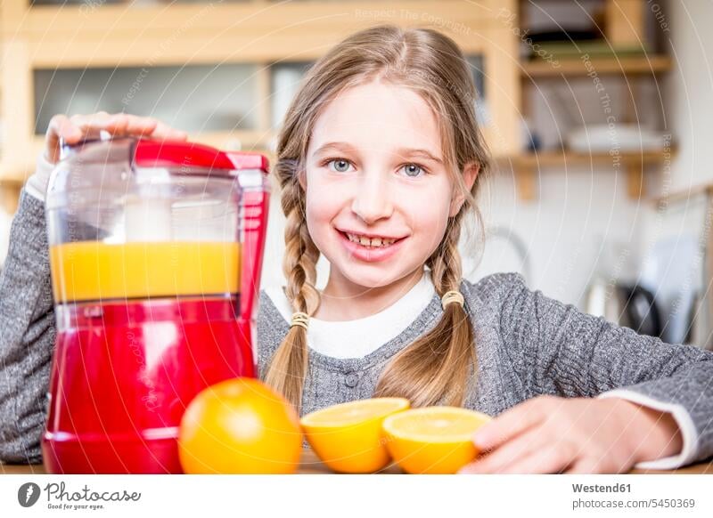Porträt eines lächelnden Mädchens, das frisch gepressten Orangensaft herstellt Küche Küchen weiblich Apfelsinen Kind Kinder Kids Mensch Menschen Leute People