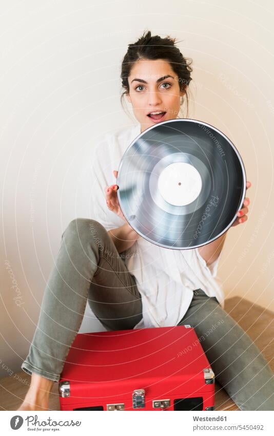 Porträt einer Frau mit Schallplatte und Plattenspieler Vinyl Schallplatten weiblich Frauen Portrait Porträts Portraits analog Medien Medium Erwachsener