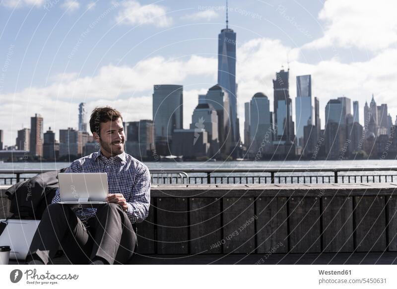 USA, Mann mit Tablette am Hafen von New Jersey mit Blick auf Manhattan lächeln New York New York State Tablet Computer Tablet-PC Tablet PC iPad Tablet-Computer