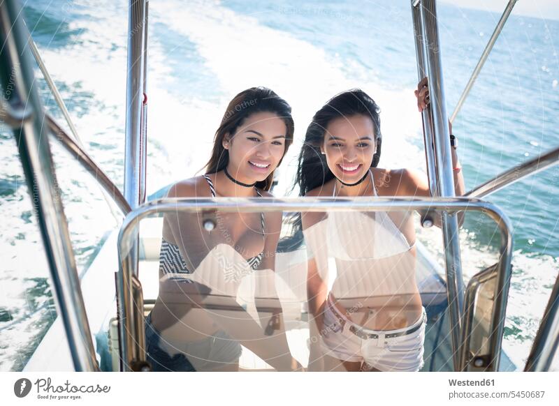 Zwei junge Frauen auf einer Bootsfahrt Freundinnen Freizeitkleidung casual Freizeitbekleidung Dreiviertelansicht Zuversicht Zuversichtlich Selbstvertrauen