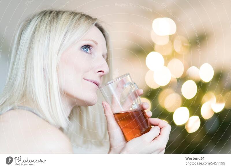 Blonde Frau genießt ein Glas Tee Tees genießen geniessen Genuss blond blonde Haare blondes Haar Getränk Getraenk Getränke Getraenke Food and Drink Lebensmittel