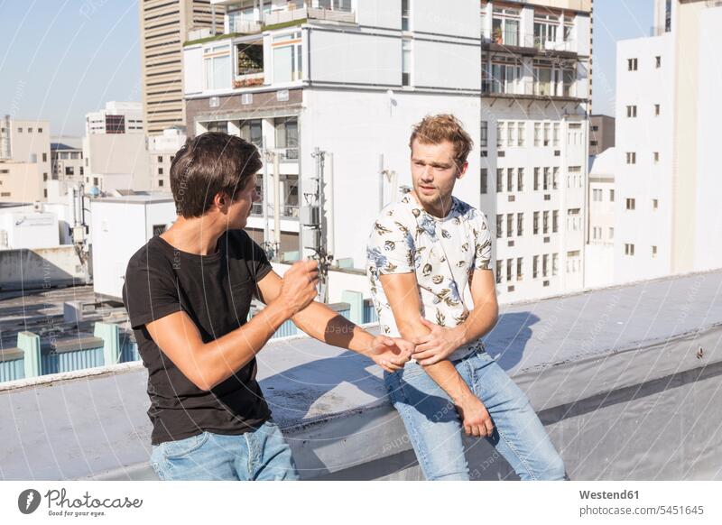 Freunde unterhalten sich auf einer Dachterrasse Europäer Kaukasier Europäisch kaukasisch Kommunikation Telekommunikation Freizeit Muße Sommer Sommerzeit