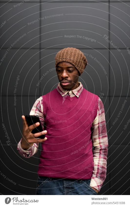 Porträt eines Mannes, der auf ein Mobiltelefon schaut Portrait Porträts Portraits Männer männlich Smartphone iPhone Smartphones Erwachsener erwachsen Mensch