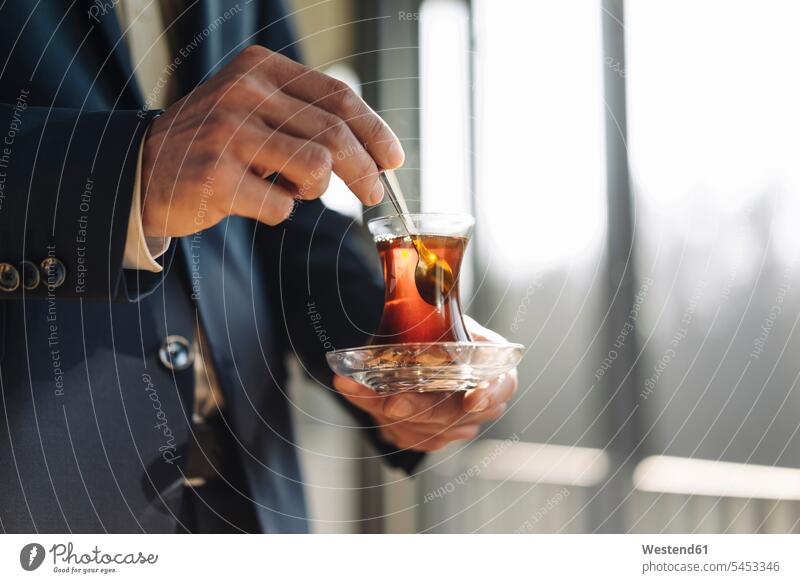 Geschäftsmann hält ein Glas türkischen Tee Tees Businessmann Businessmänner Geschäftsmänner Getränk Getraenk Getränke Getraenke Food and Drink Lebensmittel